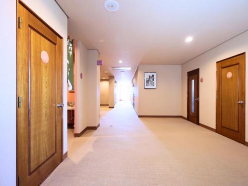a hallway with two doors and a hallwayngth at Oyado Hachibei in Takayama