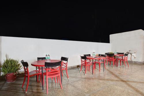a group of red tables and chairs in a room at Hindustan By Backpackers Heaven - Traveller's Choice Award 2025 Best of Best Winning Hotel in New Delhi