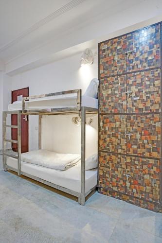 a room with two bunk beds in a brick wall at Hindustan By Backpackers Heaven - Traveller's Choice Award 2025 Best of Best Winning Hotel in New Delhi