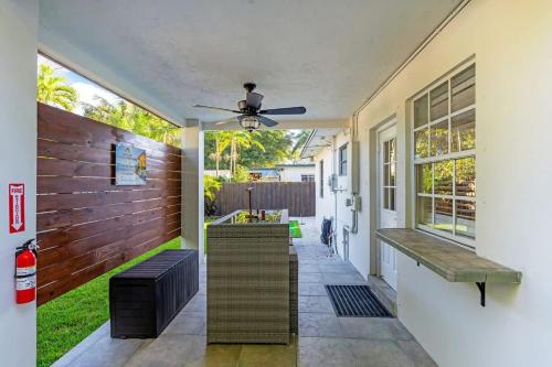 a porch with two benches and a ceiling fan at Bright and Cozy Home in Homestead in Homestead