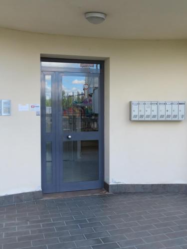 an entrance to a building with a glass door at L'attico Rinascente in Signa