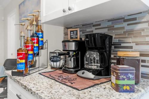 a kitchen counter with a coffee maker on a counter top at Bright and Cozy Home in Homestead in Homestead