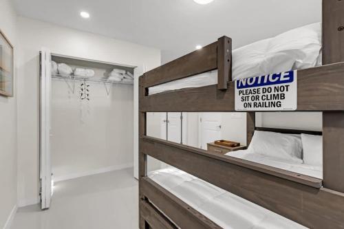 a bunk bed with a sign on it in a room at Bright and Cozy Home in Homestead in Homestead