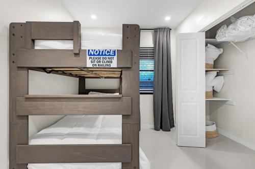 a bedroom with a bunk bed with a sign on it at Bright and Cozy Home in Homestead in Homestead