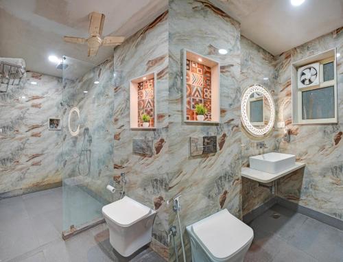 a bathroom with two toilets and a sink and a shower at Hindustan By Backpackers Heaven - Traveller's Choice Award 2025 Best of Best Winning Hotel in New Delhi