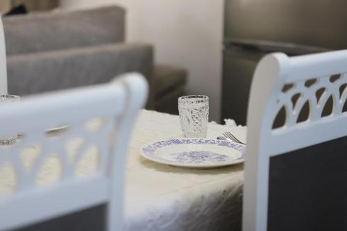 a table with a plate and a glass on it at Villa Prendi Mbreshtan in Mbreshtan