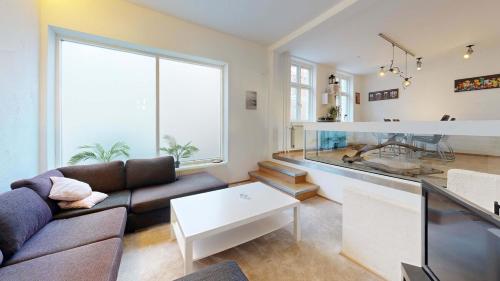 a living room with a couch and a table at Nimastay - Central Aalborg Haven in Aalborg