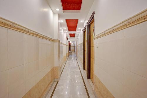 a hallway with white walls and a long hallway with doors at Hindustan By Backpackers Heaven - Traveller's Choice Award 2025 Best of Best Winning Hotel in New Delhi