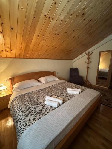 a bedroom with a large bed with two towels on it at konaku in Tomin