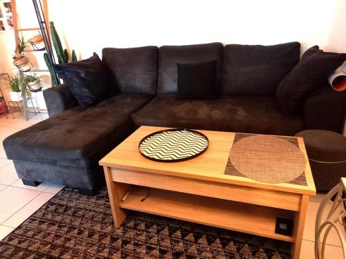 a living room with a brown couch and a coffee table at BLUE HORIZON T4 3 bedrooms Panoramic sea view in Saint-Raphaël