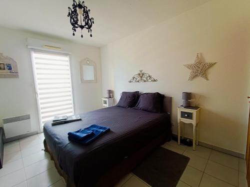 a bedroom with a bed with a blue towel on it at BLUE HORIZON T4 3 bedrooms Panoramic sea view in Saint-Raphaël