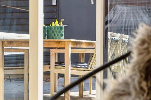 a wooden table and chairs on a patio at Nimastay - Modern Family Townhouse in Charming Risskov in Risskov