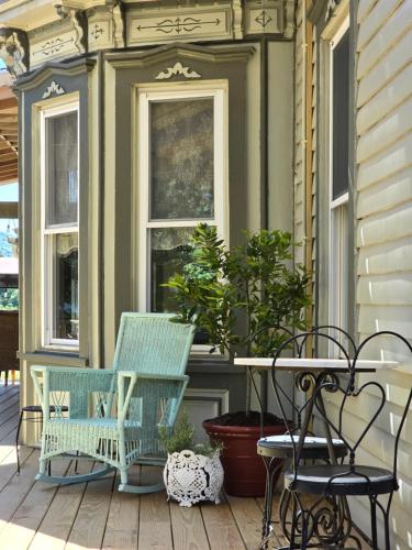two chairs and a table on a porch at Albergo Allegria Hotel & Breakfast Restaurant in Windham