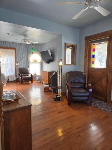 a living room with a couch chair and a tv at Albergo Allegria Hotel & Breakfast Restaurant in Windham