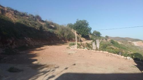 a dirt road on the side of a hill at Casa de campo in Al Hoceïma