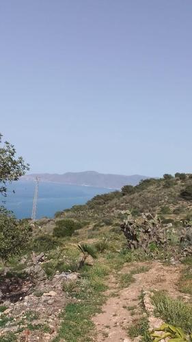 a view of the ocean from the top of a hill at Casa de campo in Al Hoceïma