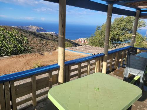 a table on a porch with a view of the ocean at Casa de campo in Al Hoceïma