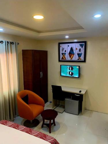 a room with a desk and a chair and a computer at Somek Homes2 in Lekki