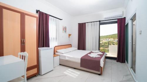a small bedroom with a bed and a window at Hotel Sema in Patara