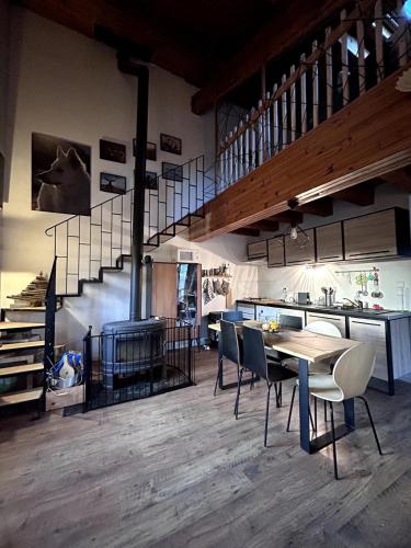 une pièce avec une table, des chaises et un escalier dans l'établissement Maison cosy, garage, jardin, terrasse vue montagne, à Font-Romeu-Odeillo-Via