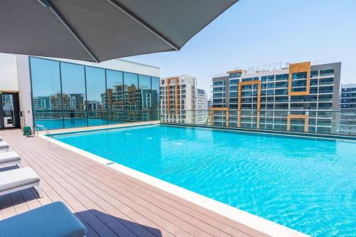 a large swimming pool on top of a building at SettlerHomes - 2BR Downtown Haven, Ideal For Family Comfort in Dubai