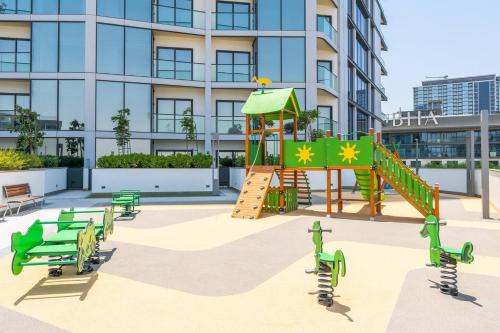 a playground in front of a building at SettlerHomes - 2BR Downtown Haven, Ideal For Family Comfort in Dubai