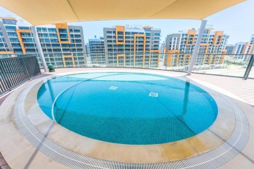 a large swimming pool on the roof of a building at SettlerHomes - 2BR Downtown Haven, Ideal For Family Comfort in Dubai