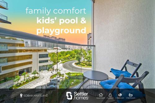 a balcony with two chairs and a table and a view at SettlerHomes - 2BR Downtown Haven, Ideal For Family Comfort in Dubai