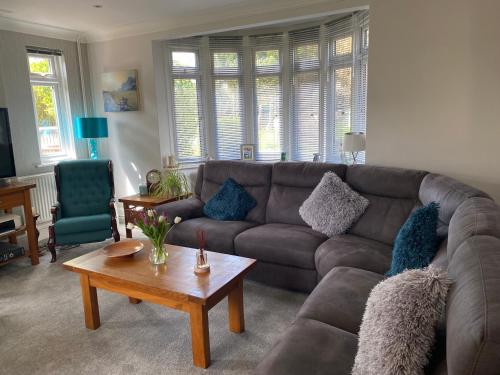 a living room with a couch and a coffee table at Home from home in Hastings