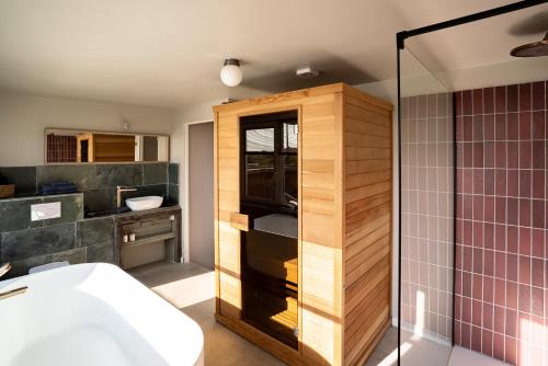 a bathroom with a shower and a sink at Maas Suites (Maastricht - Lanaken) in Lanaken