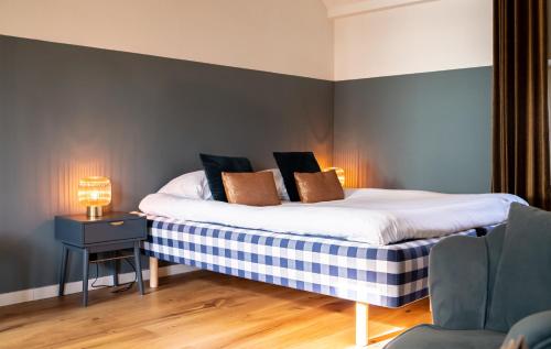 a bedroom with a bed with two pillows on it at Maas Suites (Maastricht - Lanaken) in Lanaken