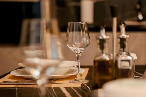 a glass of wine sitting on top of a table at N'Gen Luxury Villas - Razem in Razëm
