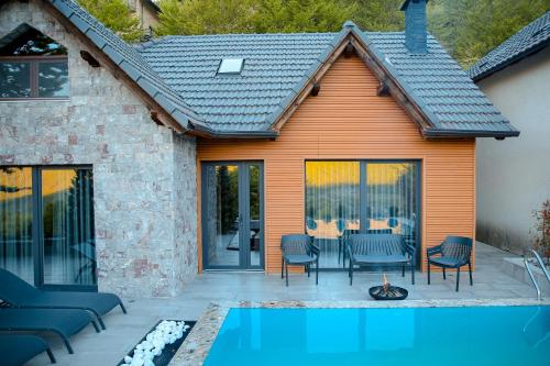 a house with a swimming pool and a patio at N'Gen Luxury Villas - Razem in Razëm