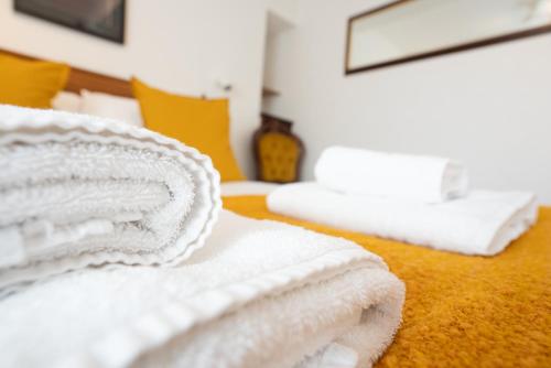 a pile of white towels sitting on a bed at Without A Paddle Hotel in Llangollen