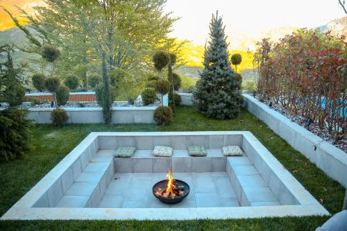 a fire pit in the middle of a yard at N'Gen Luxury Villas - Razem in Razëm
