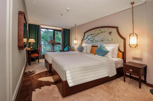 a bedroom with a large bed in a room at Rue de L'amour Boutique Hotel Ha Noi in Hanoi