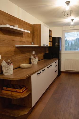 a kitchen with white cabinets and a wooden counter top at Privat Agapi in Vrbov