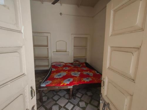 a bedroom with a bed in a room with two doors at ShreeJi Dham in Mathura