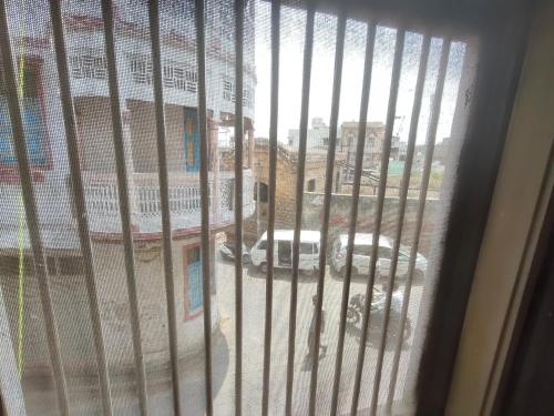 a view of a street from a barred window at ShreeJi Dham in Mathura