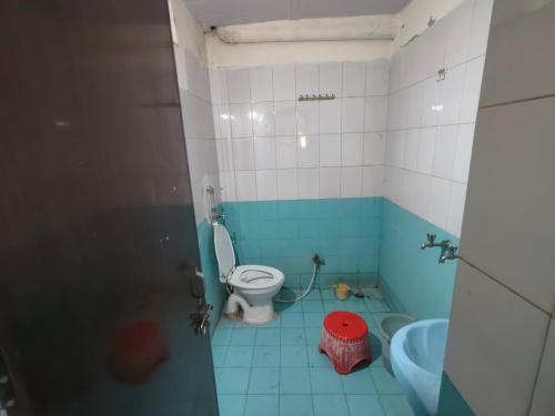a bathroom with a toilet and a sink at ShreeJi Dham in Mathura