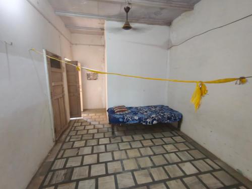 a room with a blue bench in a room with a rope at ShreeJi Dham in Mathura