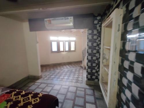 a room with a tile floor and a hallway at ShreeJi Dham in Mathura