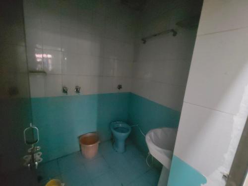 a bathroom with a toilet and a sink at ShreeJi Dham in Mathura