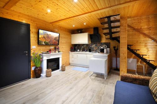 una cocina con paredes de madera y una escalera en una habitación en Green Kub, en Slănic-Moldova