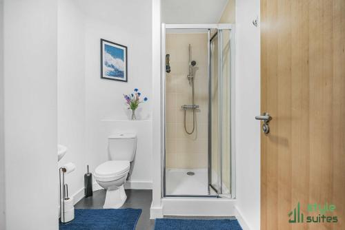 a bathroom with a toilet and a glass shower at Flat in Old Trafford Manchester in Manchester