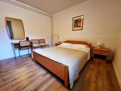 a bedroom with a bed and a mirror at Bruno's Rooms in Bašanija