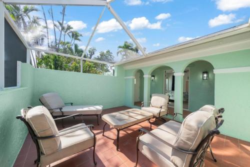 a room with chairs and a table and windows at Tipsy Turtle in Sanibel