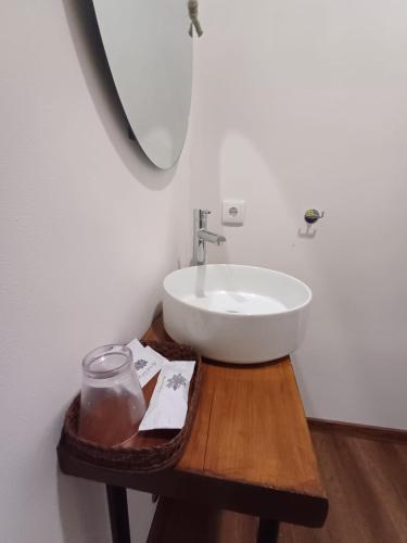 a bathroom with a white sink on a wooden table at Boa Ventura Home in Porto