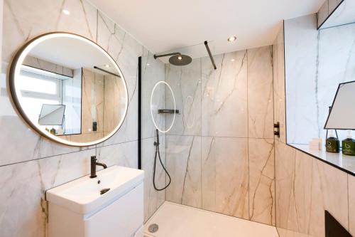 a bathroom with a sink and a mirror at Carbis Bay and Spa Hotel in St Ives