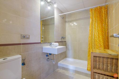 a bathroom with a sink and a toilet and a shower at Views of the Blue in Torrox